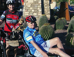 Photo of Payton and Bob Davies with their dog and bicycles. Link to their story.