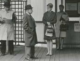 Photo of people waiting at the train station. Link to Arthur J. Bell's story.